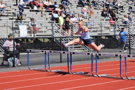 Reaching new heights, Watts sprints the 300 meter hurdles at the 2023 Northwest Invitational track meet. With her best time at 48.27 seconds, Watts qualified for the 2022 MSHSAA Track and Field State Championships and placed 11th as a junior. “My greatest accomplishment is competing at [the state championships]. I remember breaking two personal records at Conference and medaling in all of my events and feeling on top of the world. I knew at that moment that I had a chance to go to state. My favorite track memory is running the 300 hurdles at sectionals and getting fourth, barely making it to state. I remember finishing the race and running toward my hurdles coach [Kat] Briggs and yelling ‘Did I make it? Did I make it?’ She gave me the biggest smile and hug and said I made it to state,” Watts said. 