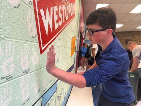 Wednesday and Thursday seniors gathered in the cafeteria to create the hand wall for 2023. Senior Joseph Britt removes his hand from the wall, leaving his mark amongst the other handprints of peers. “There’s that knowledge that we are passing down with our legacy. The hand wall is a visual representation of [our legacy] to show that we were here,” Britt said. “I remember voting [for the design] a while back and I liked the Monopoly board a lot. Seeing some of the other hand walls that are up there I like ours [the most].” 