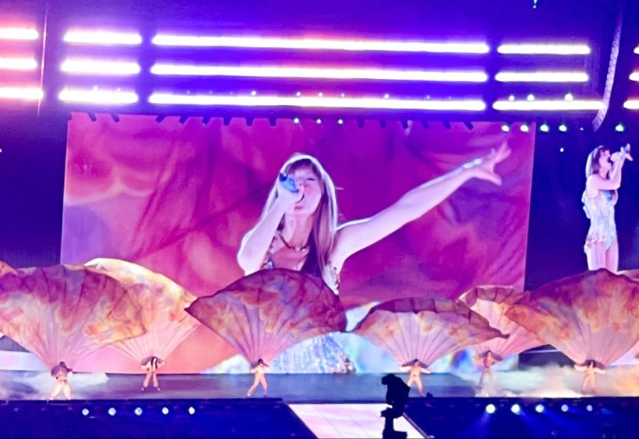Belting out her opening song, “Miss Americana and the Heartbreak Prince,” Taylor Swift fans sing along for the first performance of the Eras Tour. Dancers around Swift put on a show with large, feathery fans representing the colors of her “Lover” album.
