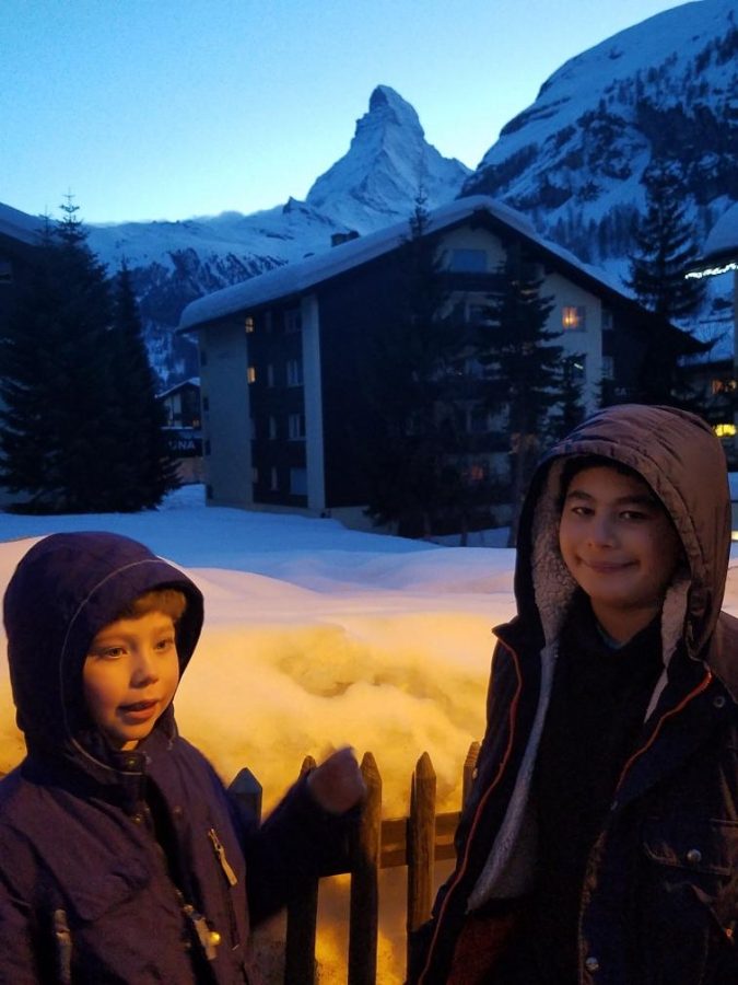 Nicholas Herman (right) standing with his younger brother in front of a hotel. “We were at a hotel. We never got much snow [near Lake Geneva] where we lived. The picture was taken somewhere in Zermatt, which is why the Matterhorn is visible in the background,” Herman said.