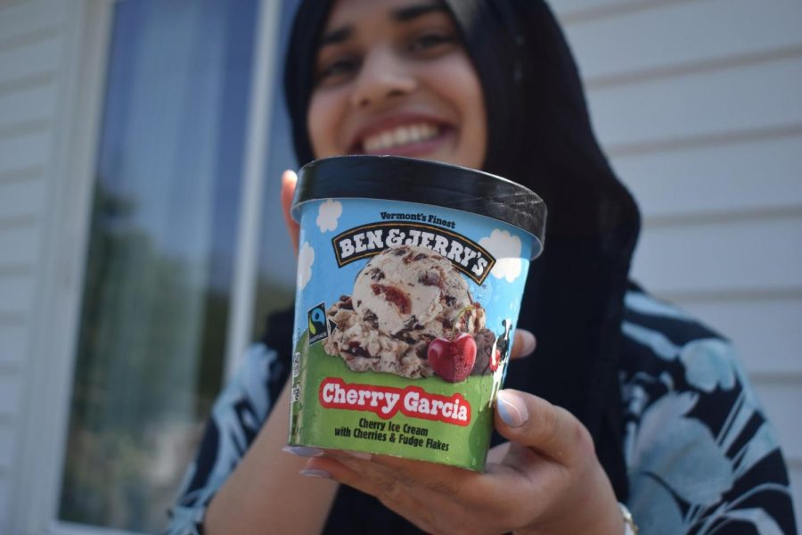 Freshman Zoya Hasan smiles while holding Ben and Jerry’s Cherry Garcia ice cream. 