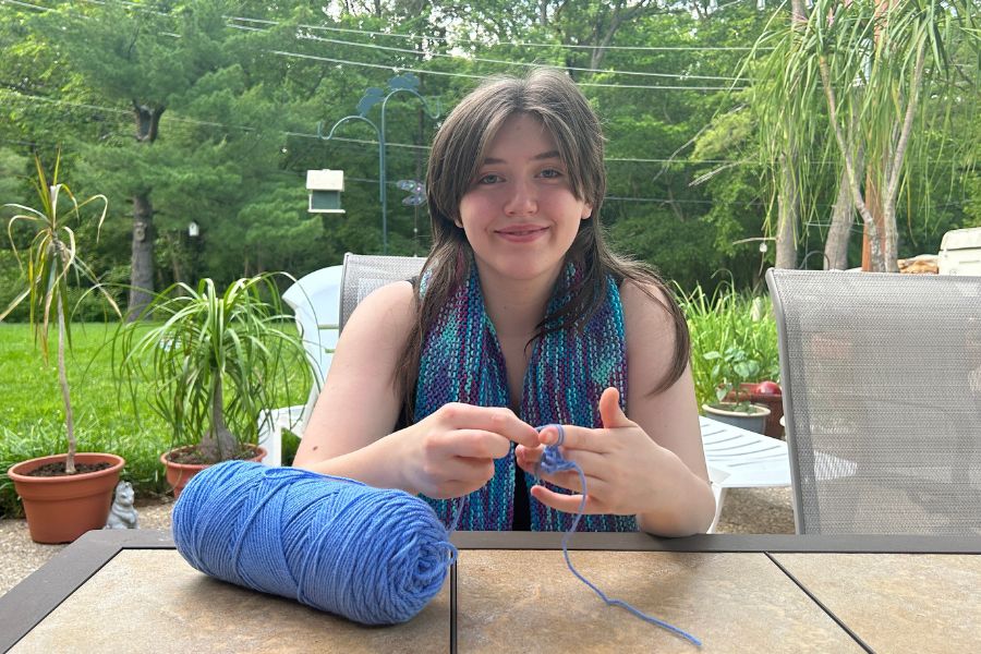 Twisting yarn, senior Carlee Priem enjoys her favorite hobby outside. Founding Yarniacs in her sophomore year has helped her to share her hobby with a larger community. “Yarniacs is one of my proudest achievements just because I think it’s a really good way for someone to get into crochet who may not know a lot about it,” Priem said.  