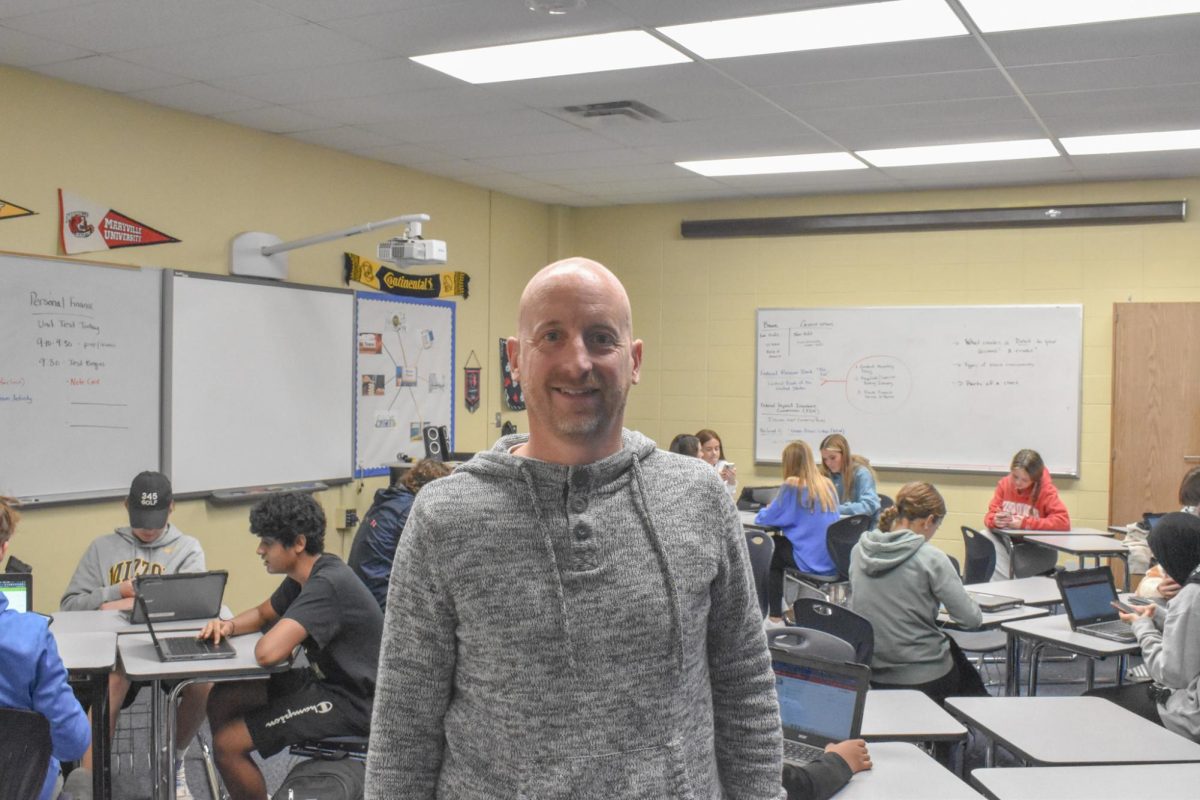 Business and personal finance teacher Andy Croley stands in front of his 5th hour, Intro to Business. In high school, business was the class Croley enjoyed most. “Business class was my favorite course in high school. I didnt know that was something I wanted to teach coming out of high school, but I wanted a business degree and to own my own business. When I entered university, I thought about a [teaching] avenue. I met with my advisor and looked at different departments. I fell in love with the people in the education department, the professors and the coursework, because it tied right into what I loved about the class when I was in high school. I fell in love with it even more when I was student teaching,” Croley said.
