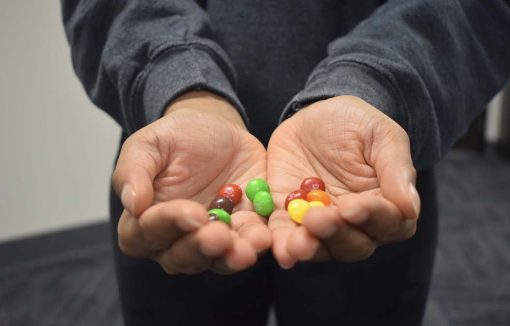 a person holding skittles