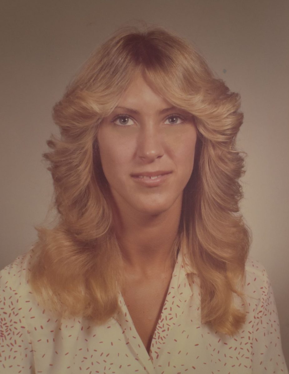 Social studies teacher Nancy Sachtleben smiles for her senior photo. She recalls how senior photos were different than how they are today.  “I remember picking that shirt because I thought it looked nice. I didn't want anything too busy or too casual. [Senior photos] were a big deal back then because you just had a couple of headshots,” Sachtleben said.