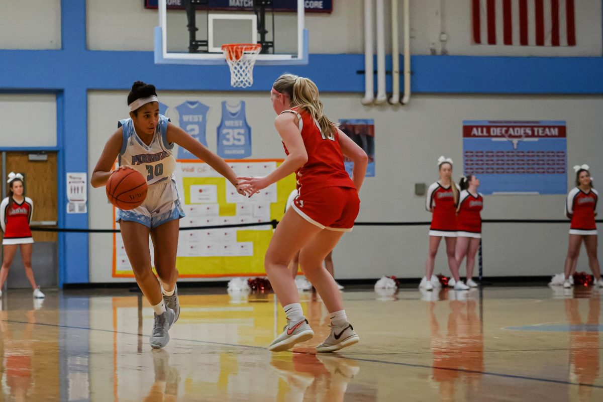 Driving+with+basketball+in+hand%2C+freshman+Ella+McNeal+dodges+her+defender.+The+girls+basketball+team+defeated+Visitation+Academy+51-36+on+Jan.+25.+%E2%80%9CWe+did+good+at+the+beginning+of+the+game%2C+but+then+we+got+better+as+we+understood+their+plays%2C%E2%80%9D+McNeal+said.+%E2%80%9CI+was+definitely+ready+for+the+game.+I+just+knew+I+had+to+come+to+play%2C%E2%80%9D+McNeal+said.+