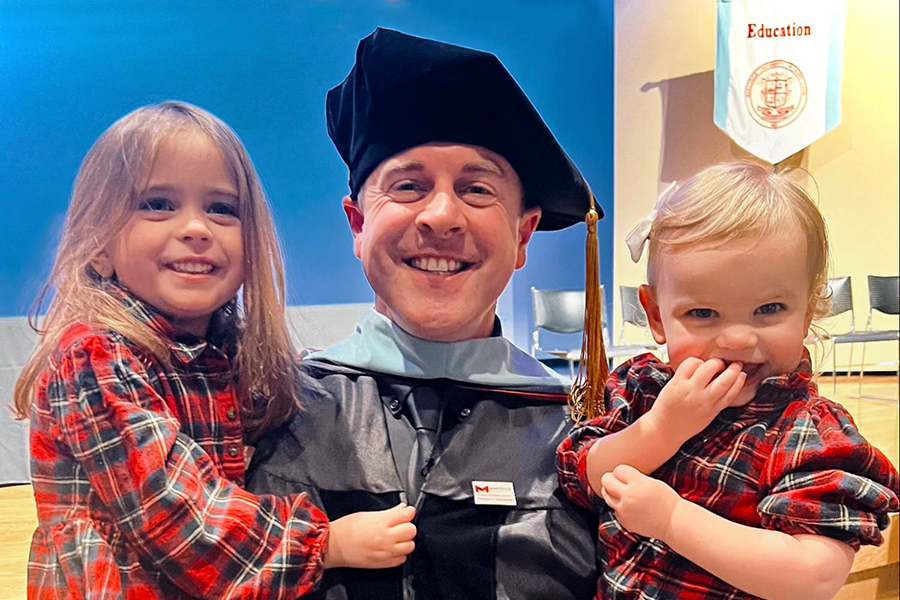Holding his two smiling daughters in his arms, Principal John McCabe celebrates earning his doctorate degree. He attended Maryville University for two years and reached his goal of achieving a Doctor of Education: Educational Leadership degree after months upon months of hard work and long nights. “Im not going to lie, Im glad I have another night of my life back when Im not at school till very late,” McCabe said. “I can spend more time with my family and with my friends [who] are here at [West]. Im really happy about that.”