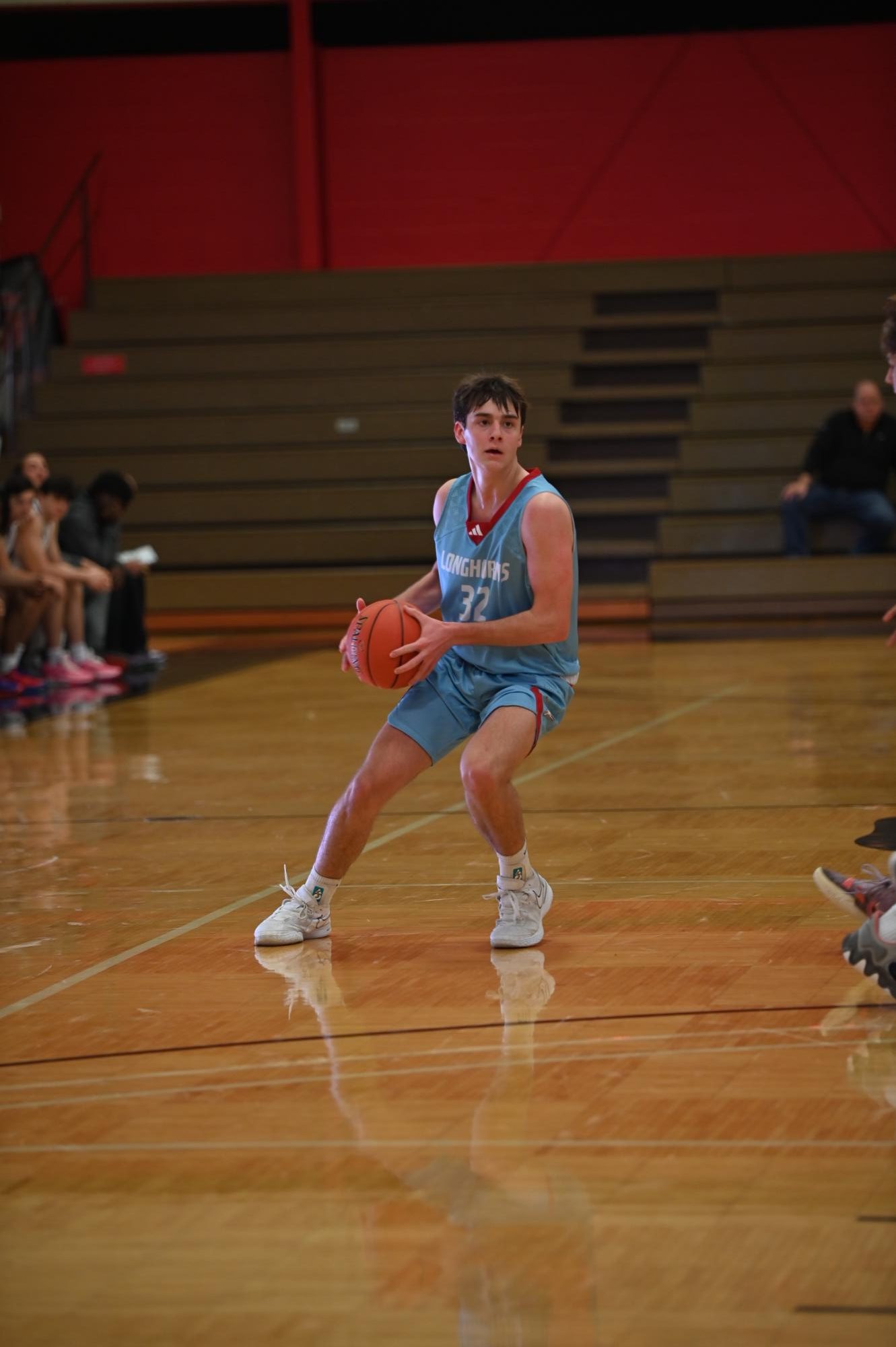 Junior Tyler (Ty) Keuhl analyzes the defense before making his move. Keuhl has been in the Longhorn Basketball Program his entire time in highschool and has started on each team he has been on. “If we play together as a team, then we will have a lot of success,” Keuhl said.
