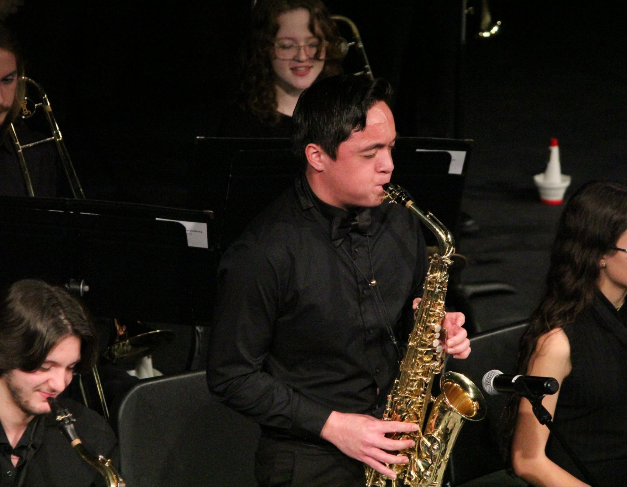 Delivering an alto saxophone solo, junior Dominic Perez performs at the Jazz Concert on Dec. 4, 2023. Perez is surrounded by his peers in West’s Jazz Band. “I try to make it a priority to not let other people change who I am,” Perez said. “I try to just be myself and not worry about what other people think of me, Perez said.