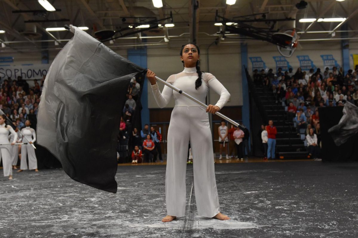 Center stage, junior Nidhi Pejathaya participates in the Winter Guard performance in the Mar. 8 Pep Assembly. Winter Guard held the student body’s attention with flags, dancing and a story throughout the performance. “This is my first year in guard. At tryouts, I preferred dance because I personally didn’t think I could do a flag, but Nicole, the [Parkway] South guard coach, noticed my work at practices and told our coach that I should be in the front. That was the biggest part for me in the show,” Pejathaya said. “I absolutely adore the team. I’ve played multiple sports and I don’t think a single one has compared to the guard team. Traditionally, we do compliment circles, you cross your right hand over your left, and say a compliment. I’ve only known these girls for three months [and] these girls are the most genuine and kind people I have ever met. You don’t need to act differently, you don’t even have to like what they like, you just have to be you.”