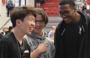 Seniors Andrew Son (left), Tommy Eschbach (center) and Kaiden Kelley (right) laugh together while waiting for their robot, OverDriv6, to compete at the 2024 Missouri VEX State Championship. Although the competition was stiff, the trio managed to have a good time, content with their performance and teamwork. “We’re very good at recognizing small victories while in the face of adversity. If one of our subsystems failed or one of the parts of our robot broke, we'd spend half an hour or so fixing that. The next match, even if we lost, we'd still celebrate the fact that that adjustment we made ended up working and succeeding. Being able to celebrate minor victories was very good for our team chemistry and strength,” said Eschbach. (Photo by Mikalah Owens)