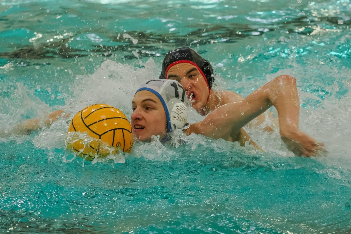 Arms flying above water, sophomore Max Moore dribbles the ball away from his defender at the junior varsity water polo game against Parkway Central on April 22. Moore relied on his speed to move away from his defenders in the pool but focused on mindset and communication while leading his team. “My typical mindset during a difficult game is to try to stay calm to set an example for everyone so they don’t panic. [I also] think of ways to get us back in the game. I usually think about things that keep me happy if a game gets tough. It keeps me calm and [I can] play better,“ Moore said. 