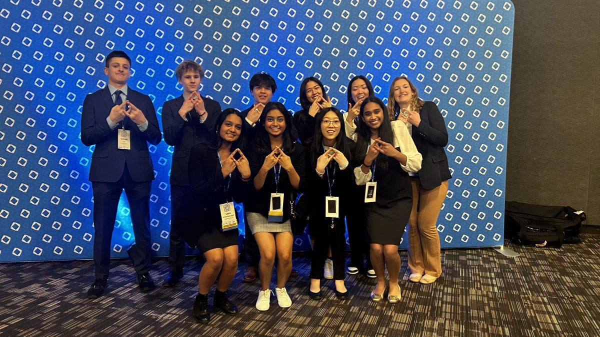 Smiling with Parkway North seniors Sarah Ham and Alison Lam (second and third from right), eight West state qualifiers hold up the iconic DECA symbol. The program has connected over 7,000 high schoolers, giving students the opportunity to network and expand their social circle. “Getting along with people that might be different from you is the most important part of DECA. You learn things about people that you originally wouldnt talk to, and its nice to know how to work with other people [as well as] make new friends in a different area,” junior Laya Krishnakumar said. Courtesy of Laya Krishnakumar