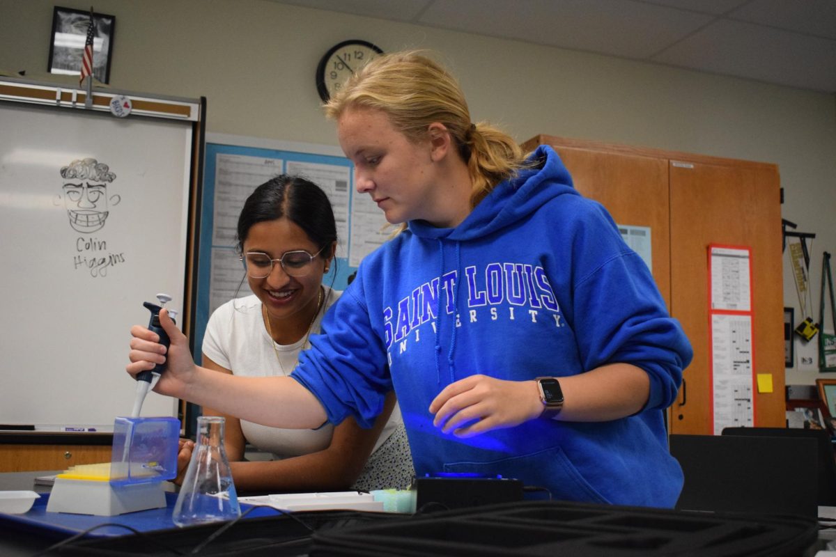 With a steady hand, junior Lucy Moore participates in a gel-electrophoresis lab in Biology 3. The lab procedure required the use of a micropipette to discover the length of DNA through electric waves. Moore and her partner, junior Nidisha Pejathya, have completed many lab experiences throughout the year. “I like how Bio 3 is set up. Its fun to work physically with something and see it for myself instead of doing it online,” Moore said.