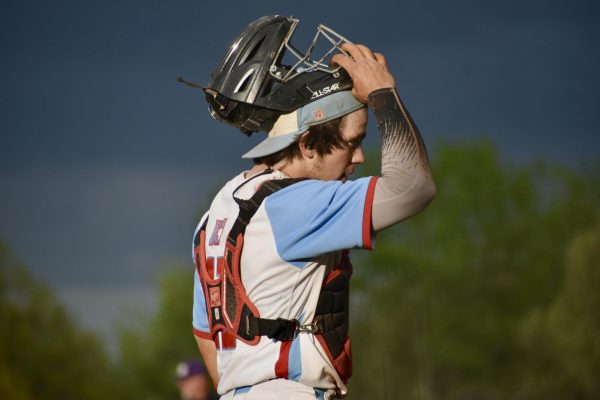 Putting on his helmet, catcher and senior Tommy Eschbach prepares to get in his primary stance. Despite losing 6-1 against Eureka on April 16, Eschbach didn’t let the tough loss affect his playing or mental health. “It's [so] easy to get caught up in the sport and what you're doing that [after] one bad game or a stretch of games it is hard to remind yourself that your worth as a person isn't directly related to your performance on the field,” Eschbach said.