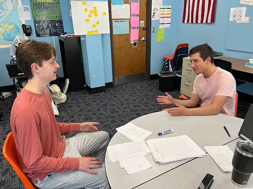 Senior Michael Emerson exchanges ideas with junior Will Gonsoir in history class. They discussed immigration as the topic of their debate. “I really enjoyed the experience. I think it opened my mind to new ideas, and that’s what matters at the end of day,” Emerson said. 