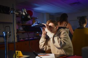 Immersing himself in an astronomy experiment, junior Brady Moriarity discovers the various types of light present in his classroom. Just preceding the lab, he was introduced to the concept of light frequencies and the tools used to make them visible to the human eye. “I didn't know anything about light, so it was cool to see the different colors and bars of light. I like learning about space and astronomy;  it's interesting how it's all pretty much endless,” Moriarity said.