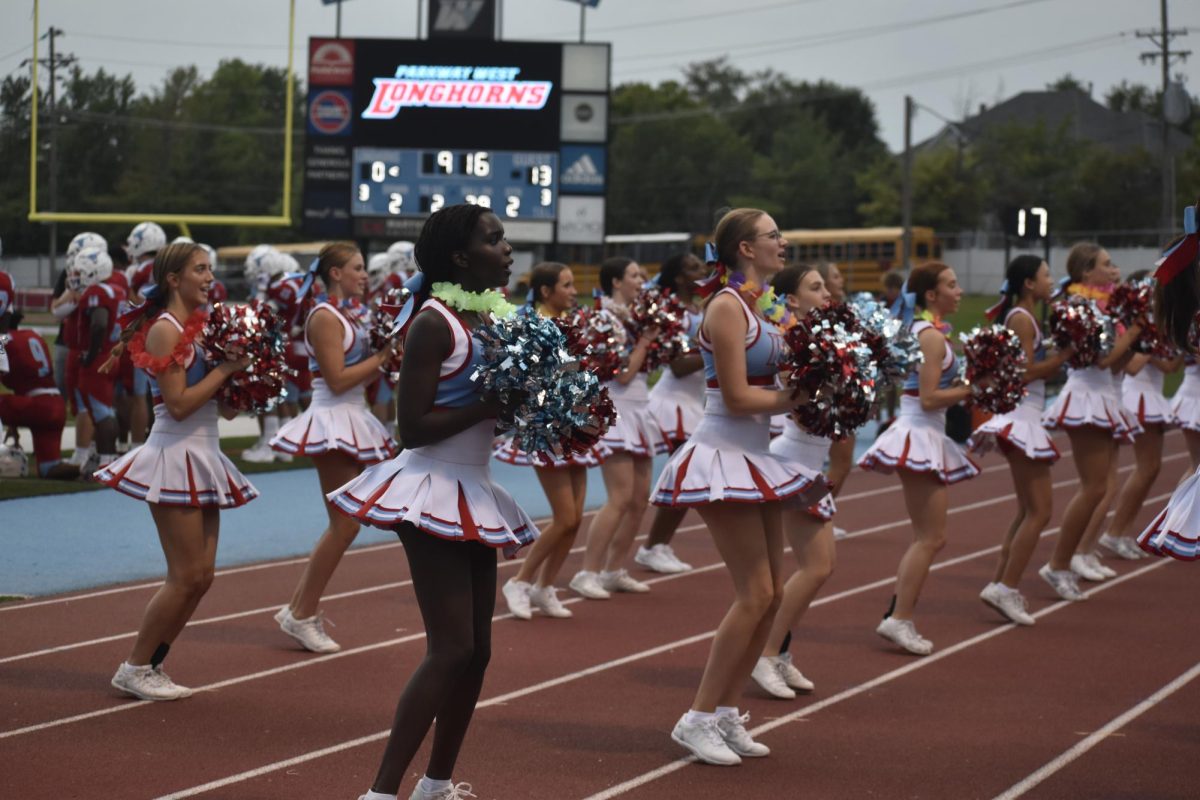 Leis bouncing in the wind, sophomore Alyssa Gessner and the varsity cheerleading squad stay on theme with the student section. The fan-favorite theme of the night was tropical. “My favorite part about cheer is the connections I have made with all of my friends who have [helped] guide me through high school so far. Becoming friends with last year's seniors as a freshman made me strive to become a role model to the little girls at kid camps,” Gessner said. 