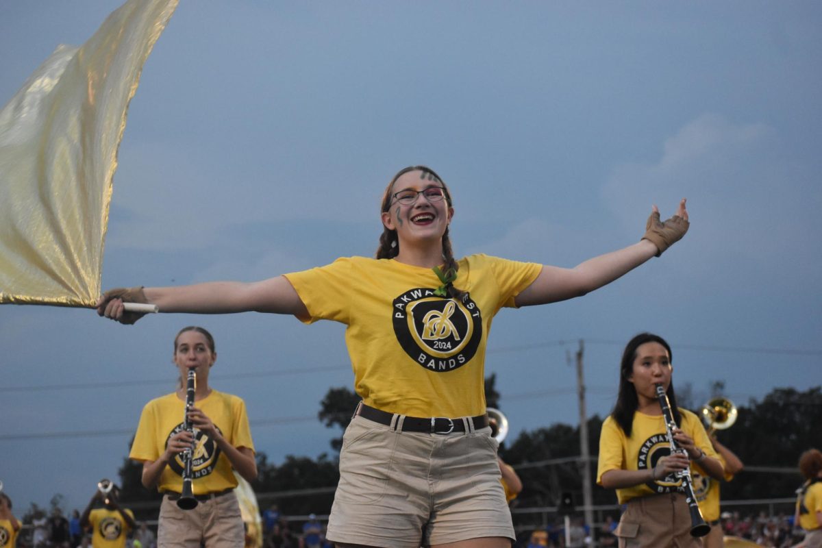 “It’s my third year and fifth season of doing color guard. My mom did it when she was in high school and college, so I’ve always wanted to do it too. It's definitely [a team and individual sport] because you have parts that have to [be cohesive and] perfect. You could be [fine] on your own, but if you're not working together, you're not going to do well. When I'm standing [on the turf] about to perform I go over counts and [memorize] tricky parts in my head, and before we go on, we always practice as a group and individually. [The only way to improve is to] practice, because if there's a toss, trick or part of the work that [I]  don't know, there's nothing [I] can do except [to] ask for help and practice until [I] get it right. I like the team aspect of it, even more than I like the performance because [there is] such an [amazing] group of people and without them, it wouldn’t be as fun.” - Victoria Gold, 11