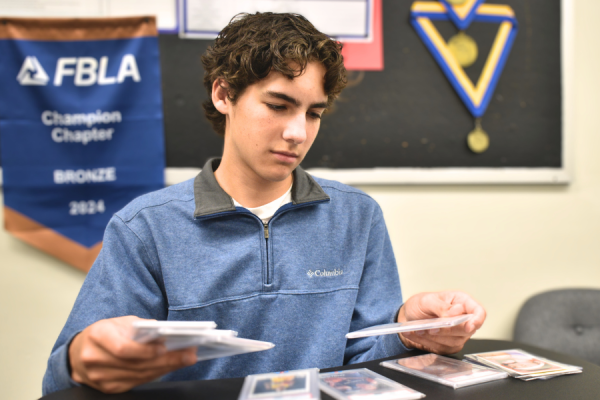 Junior Justin Lutz arranges his collection of basketball sports cards. Lutz started his first hand at entrepreneurship with an online store on eBay, dealing and trading in the sports card market. “I was already collecting sports cards [before], so I knew a lot of these players and I understood the market. I ventured into other sports, but I really stayed with the ones that I knew the most, [like] basketball. It’s really important to focus on what you know because it's so much easier than starting completely from scratch in a market that you don't understand. Find something that you're interested in," Lutz said.
