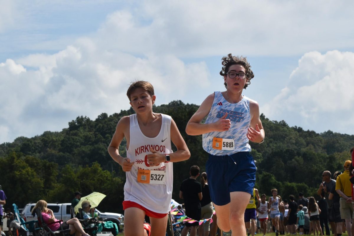 Swinging his arms to maintain momentum, freshman Maxwell Rahm races at his first-ever meet, the 2024 Stan Nelson Invitational. At the meet, Rahm persevered and placed 10th overall. “My legs were really tired that race, and I didn't like my performance, but I am glad I medaled. We have a meet tomorrow and my main goal is to keep going, even [when] it's hard,” Rahm said.