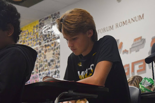 Eyes tracing his book, freshman Auggie Prsha works to translate a passage in Latin teacher Tom Herpel's classroom. Prsha decided to take Latin after hearing about the fun classroom activities, but he quickly began to see the effects of learning a foreign language in the world around him too. “Sometimes in English class, I can [recognize] some Latin words, and I notice Latin in other places [as well]. I enjoy the people [and] learning from Herpel,” Prsha said.
