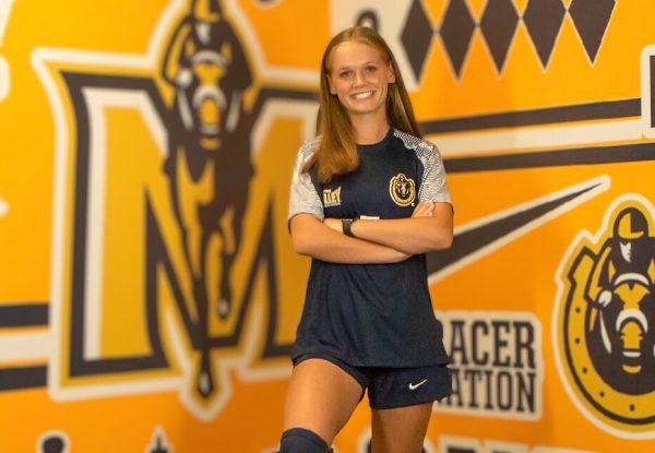 Posing at Murray State University, junior Kathryn Hardy confirms her Division I commitment to play soccer in college. Hardy played soccer for the majority of her life, but over the summer, her dreams of playing college soccer were fulfilled. “Going into junior year, I went to a couple of identification camps. I went to the Murray State ID camp, and that’s where the coach saw me playing,” Hardy said.