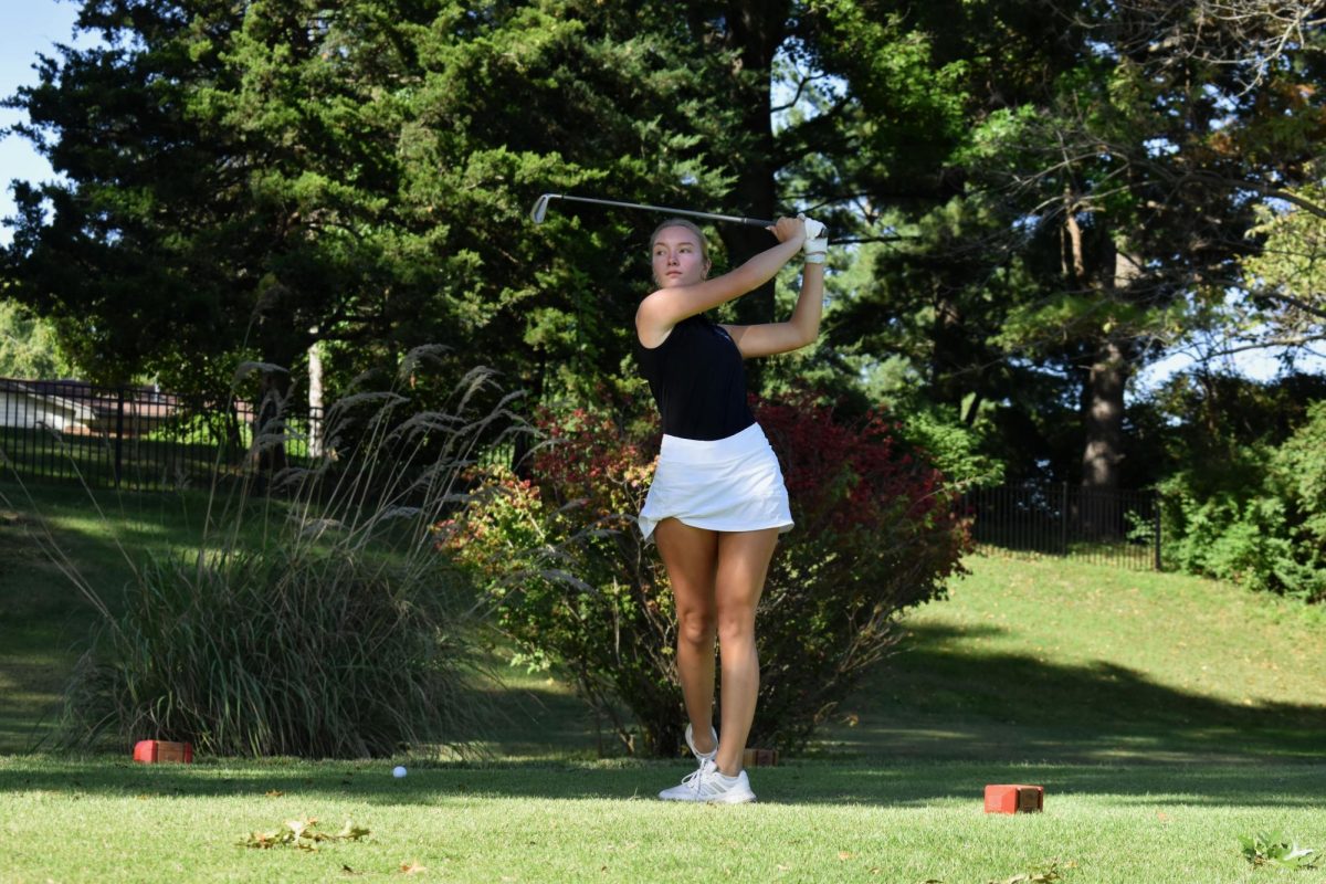 Raising her club above her head after following through in her swing, senior Karry Nickel’s gaze follows her ball’s trajectory. On Oct. 1, the varsity girls’ golf team had their second-to-last tournament as well as their senior night, in which they celebrated Nickel with hand-drawn shirts, flowers, balloons and a cookie cake. “This is my first year on the golf team. I played golf when I was younger, so I decided to come back for my last year because I knew [it] was fun. [This tournament] was one of our last matches all playing together, and it was kind of sad. [But,] we got second place and I played pretty well. I parred the last two holes, so that was a highlight,” Nickel said. 
