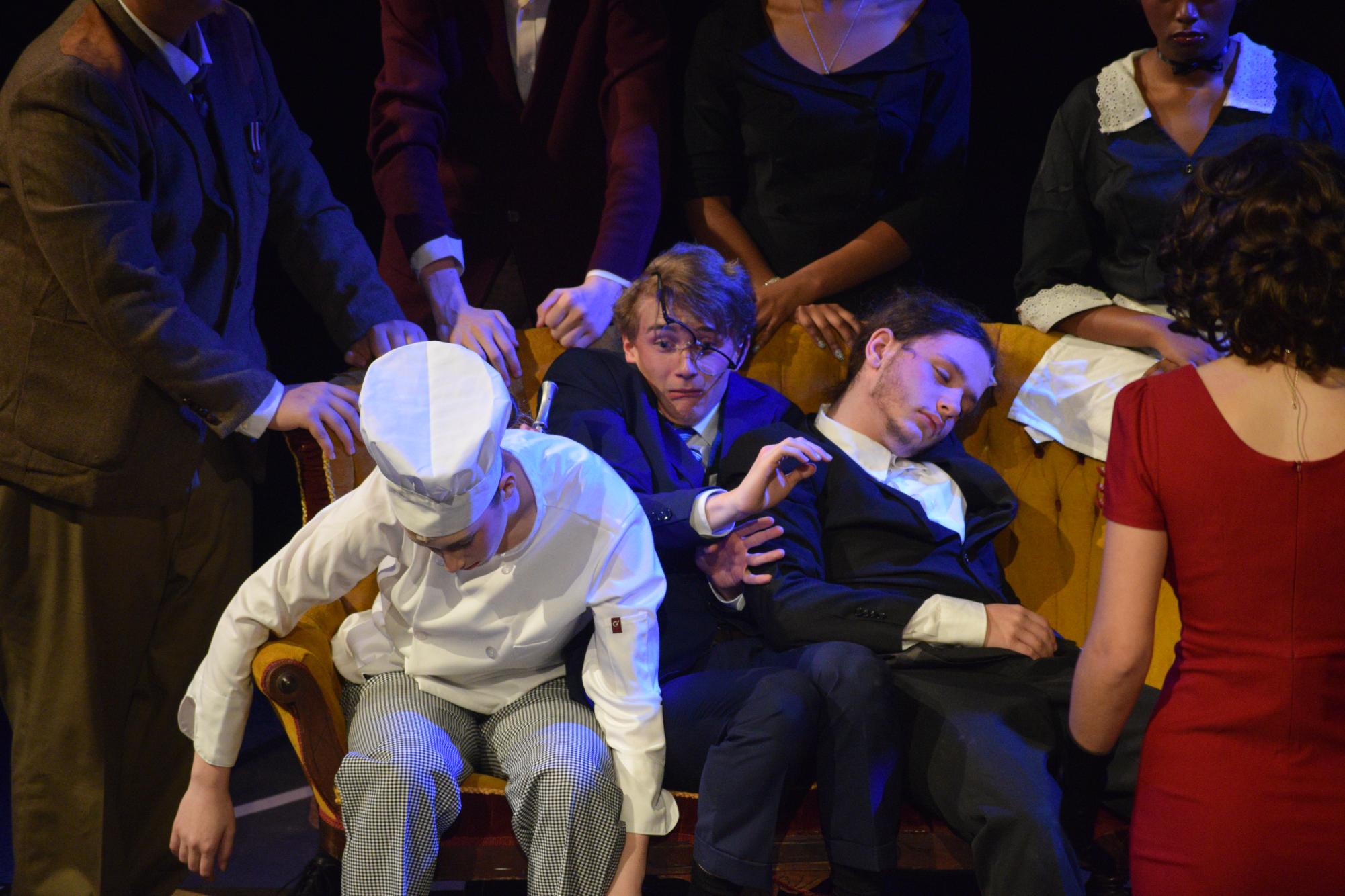 Sophomore Joe McCurdy (center), characterized as Mr. Green in the theater’s production of “Clue: On Stage” sits between two dead bodies. The task of each character was to make sure the bodies wouldn’t be discovered by the police that would soon be arriving. “In the picture, I’m squeezed between two characters and trying to get off of the couch without disturbing them. It’s definitely one of my favorite moments to act because it’s such an outlandish situation and it’s all purely physical comedy, which I love to do,” McCurdy said