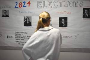 Senior Sally Peters stands in the history hallway, contemplating her choices in the 2024 United States and Missouri elections on Nov. 5. As a member of Diplomacy Club, Peters has discussed key candidates and issues in contemporary American politics. “[As students], we're starting to become adults. We're realizing how much the policies that are enforced and the laws that make it through the House and Senate are starting to affect us. [Opportunities such as] AP [U.S.Government] and Diplomacy Club [make elections feel] a lot more real,” Diplomacy Club vice president and senior Nidhisha Pejathaya said.