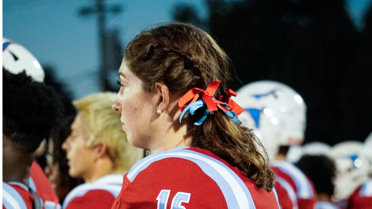 Senior Josie Grunzinger watches the football game intently from the sidelines on Oct. 18. Grunzinger stood out to the crowd as the only girl on the football team, encouraging other girls who want to play football to take a chance and go for a sport outside of their comfort zone. “If you think you could [play football] and you want to do it, just try it, because all it takes is to actually try it out,” Grunzinger said.