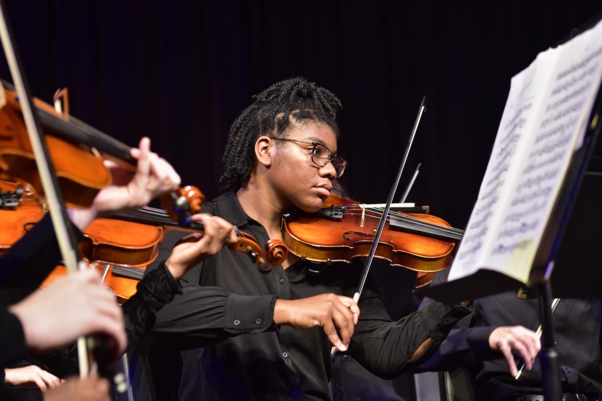 Under the stage lights, sophomore Samantha Barnes projects her talent while playing violin with Chamber Orchestra. Barnes reflected on what inspired her journey to begin. “My brother is my biggest inspiration because he was in Symphonic Orchestra. So watching him play, made me want to play more,” Barnes said.