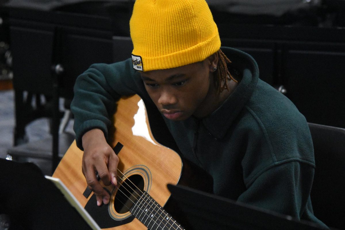 Reading sheet music in Guitar 1, junior Neiyo Hagens strums along to various chords and melodies, working to become proficient in the instrument. Though he only began learning guitar this year, Hagens’ long standing passion for making music and his friends’ support led him to give it a try. “My friend [junior] Jonah Wool plays guitar, and I loved the sound of [it], and wanted to learn how to play it. I've been making my own music for about three years now, so I would definitely like to learn how to incorporate [guitar] into my music that I make personally,” Hagens said.