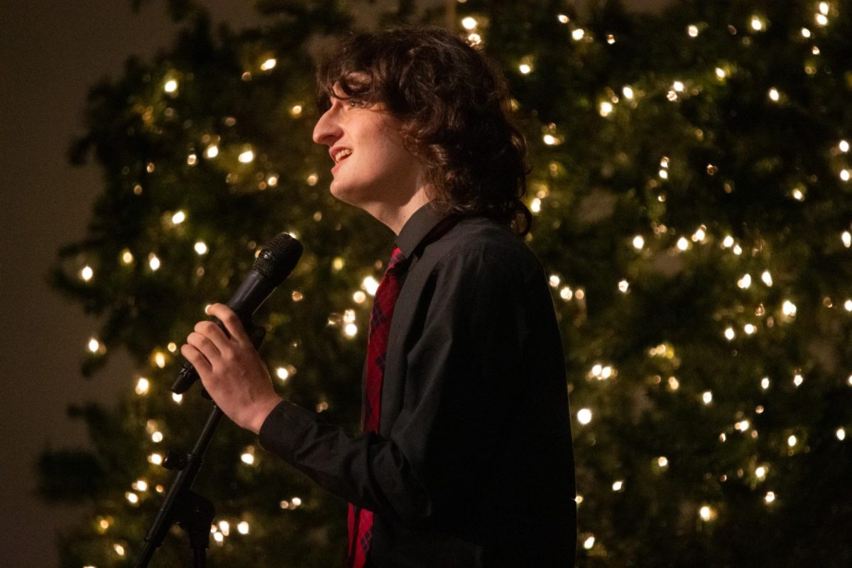 Looking out into the audience, senior Jack Mullen solos “Have Yourself a Merry Little Christmas” by Frank Sinatra at the annual winter choir concert on Dec. 10. Mullen volunteered to sing a solo to aid the transition between choir groups on stage. “I chose that song because I really like the crooner genre when it comes to holiday music. [That song] had all the element[s] of Michael bublé, Nat King Cole, Frank Sinatra and Bing Crosby. Also, it's a simple melody, so I did vocal gymnastics when I could and made it my own,” Mullen said.