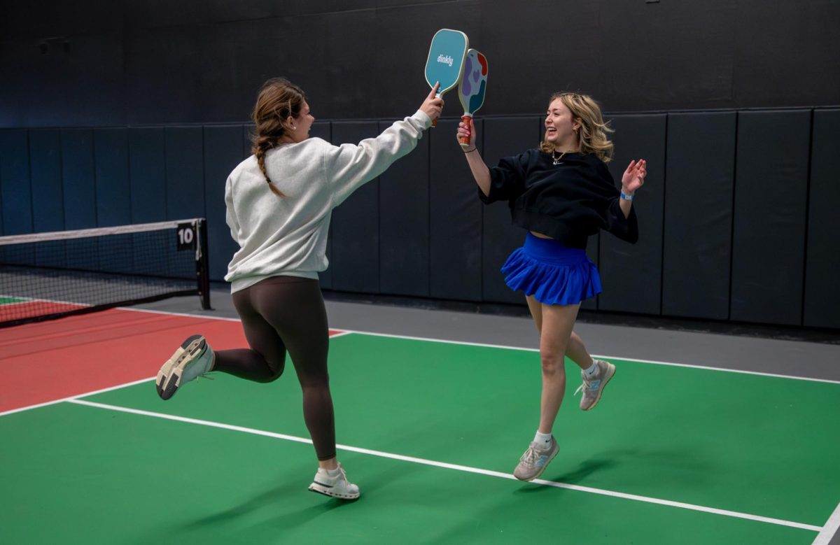 
High fives and smiles all around, senior Sadie Burgess and her partner junior Charlotte Putnam 
compete in the Red Cross Club’s pickleball tournament fundraiser at Chicken n Pickle on Feb. 1. The fundraiser benefited those recently affected by the Los Angeles wildfires. “It felt good [supporting the cause], especially since [pickleball] was easy to pick up and fun. I would have spent that $20 probably at Target anyway, so it was good that I was giving it back to something better,” Burgess said. 