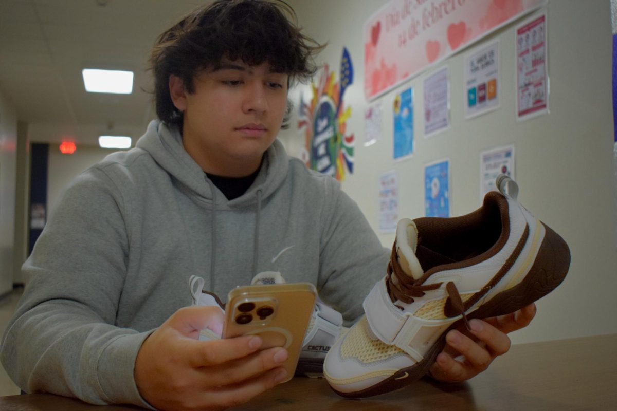 Scrolling on eBay, sophomore Ryder Williams searches the app for different shoe styles. Williams credits the impact his completion of business and finance courses have had to gain his financial success, as well as his Personal Finance teacher, Andy Croley.  “ Croley helped me a lot in getting to know more about profit and where to put the money. [He] also [taught me] how to store my money, ways to invest it [and] that I should always have emergency funds,” Williams said.