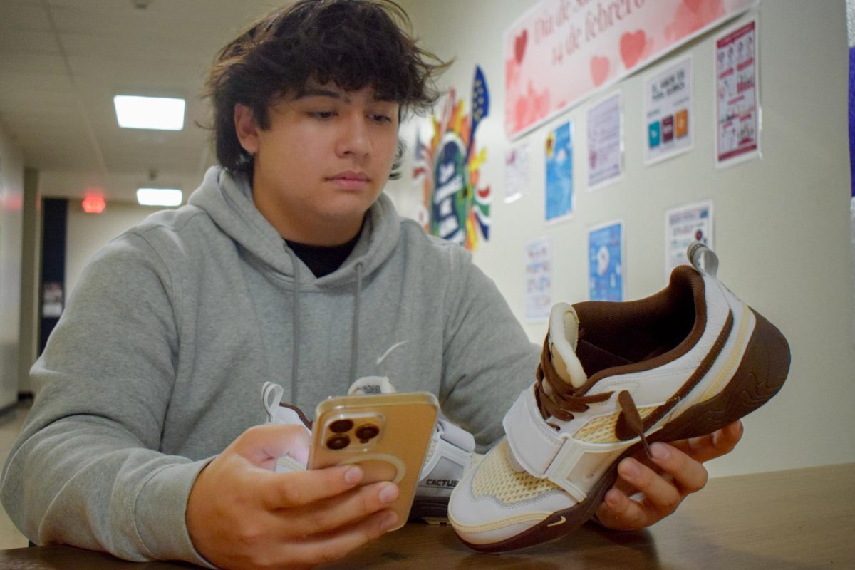 Scrolling on eBay, sophomore Ryder Williams searches the app for different shoe styles. Williams credits the impact his completion of business and finance courses have had to gain his financial success, as well as his Personal Finance teacher, Andy Croley.  “Croley helped me a lot in getting to know more about profit and where to put the money. [He] also [taught me] how to store my money, ways to invest it [and] that I should always have emergency funds,” Williams said.