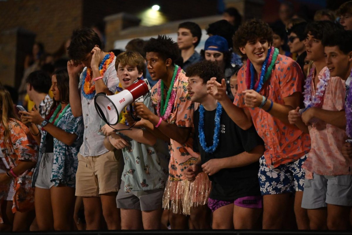 The Superfans help lead student chants and claps during a tropical-themed football game and show their support for the school's football team. Senior Henry Wild is one member of the Superfans who shows his love for the school’s sports. “At the games,I think the [atmosphere] is very good. Everybody’s standing up and cheering everyone on. It’s really exciting, especially when we’re playing [well]. Just seeing people succeed and everyone rallied around [indicates that there is] good chemistry [within the] school culture,” Wild said. 