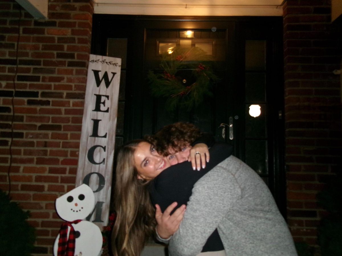 Alyssa Gessner and Sam Kitrell hugging in front of their houses about to go out. “We go out [with] family [and] friends, so it makes us feel more involved in [each other's] lives,” Sophomore Alyssa Gessner said.