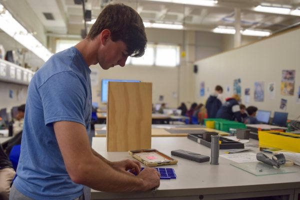  Using a micrometer, senior Nathan Thompson measures a keyguard made out of thermoplastic polyurethane (TPU), a type of durable and elastic plastic. Thompson was able to turn a 3D model for his independent studies class into a tangible object by using a 3D printer. “It’s a slow but rewarding process. Without a 3D printer, it would have been very difficult to complete this project,” Thompson said.