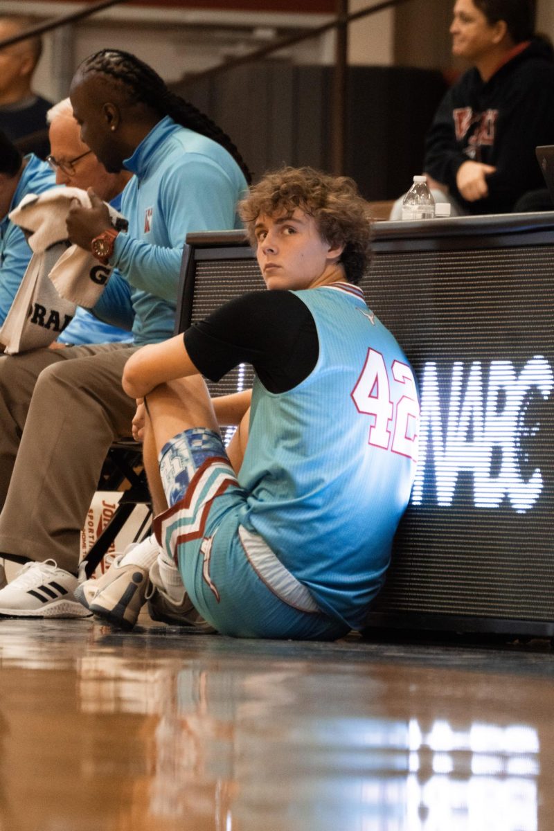 Freshman Greyson Smith waits patiently to check back into a game vs. Lutheran South (December 28th). Smith started every game this past season. “Basketball this season was fun because it was my first time playing with varsity, and it was fun to play against good competition,” Smith said.
