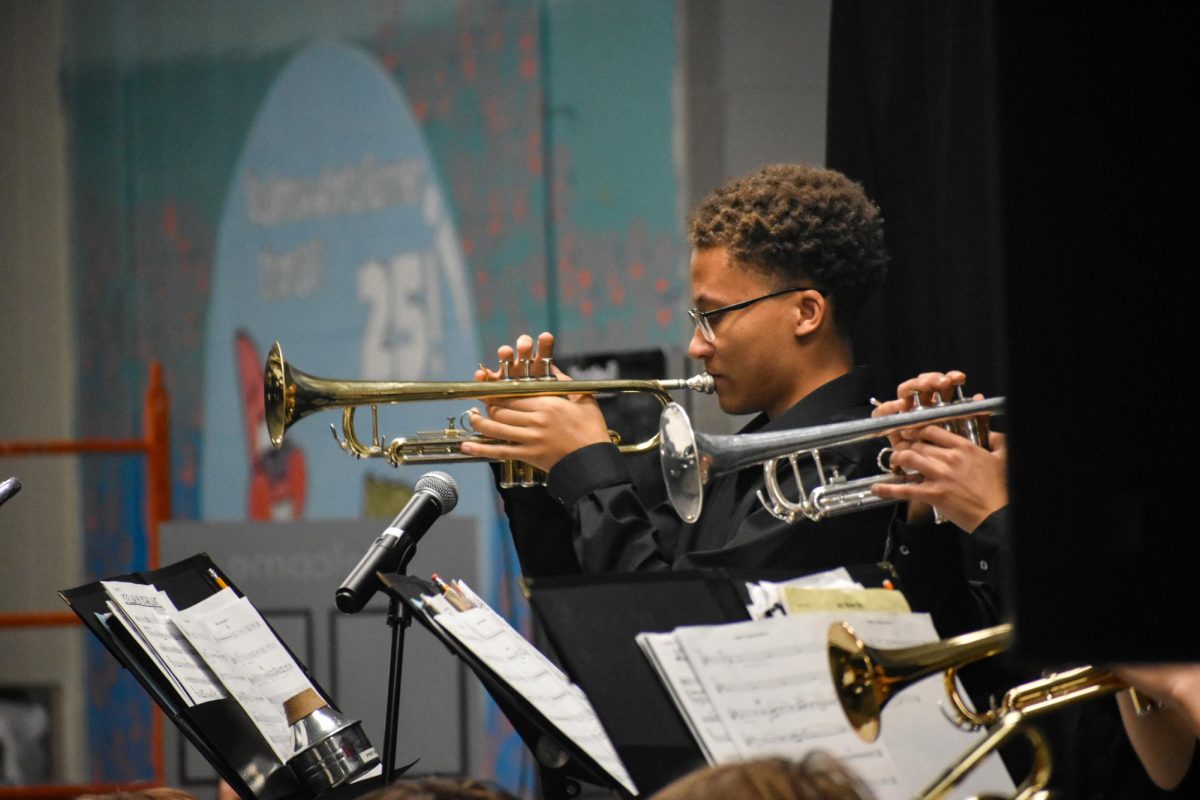 While the ensemble plays, junior Cole Kayira lifts his trumpet and delivers his part at the Jazz Coffee House concert. Influenced by his family and years of listening to music, jazz has become a deeply emotional outlet for Kayira’s musical expression.“Band isn't just music that you just play, it's something you have to find. Band is feeling. I've always loved jazz. I play it in the car before I go to school. My dad used to play on the radio. It always held a special place in my heart, since my family plays it too,” Kayira said. “Jazz Coffee House was an opportunity for me to express who I really am and how I'm feeling [in] the moment. I base my trumpet [on] that and sing to the audience.”