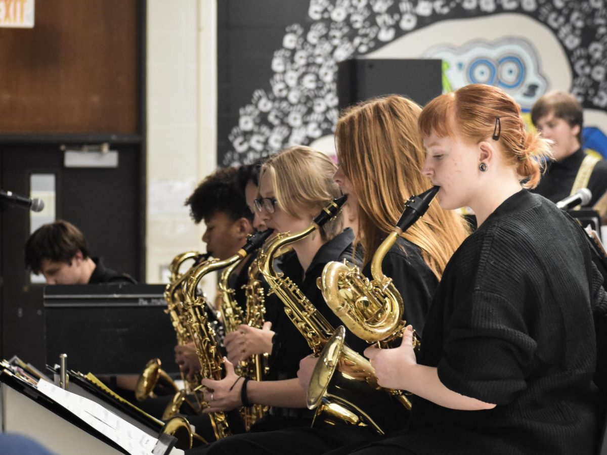 Sophomore Rowan Ravenscraft raises her instrument and merges into the ensemble’s latest set, showcasing her love for band music. Having been involved in band since sixth grade and the jazz band since freshman year, Ravenscraft sees music as a space to connect with others. “Band means a lot to me because I [found] a community. It's a happy place, a home, [and] somewhere I can always go back to. [My favorite part of playing] an instrument is being able to connect with other people because you have a connection that not everybody has,” Ravenscraft said. “[Jazz Coffee House] was a way to showcase something I love to the people I love. Being able to play and connect with the music myself is what makes me love music in the end.”