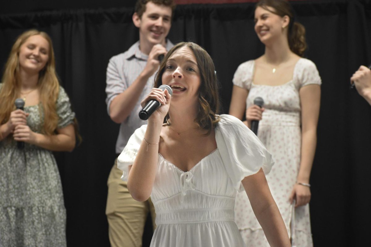 Singing into the microphone, junior Olivia Owens overlooks a crowd of family, friends, peers and teachers. She spent the year preparing for a lively duet, drawing on years of choir experience that began in fifth grade. “I was singing my solo in a song called ‘Boy from New York City’. I had a duet with my friend [that we worked] hard on. [This] song is super upbeat, and I love singing and being in the spotlight,” Owens said. “I liked being with all my friends in [the] jazz choir because they're all very supportive, and making music with them is always a fun experience.”