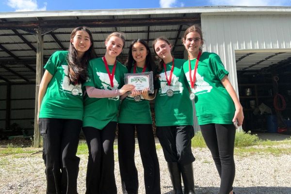 Smiling at the Missouri Envirothon state competition, the Parkway West and Parkway South Envirothon team holds their award plaque. The team placed second in the state level after completing a written test and a presentation for the competition, which covered the subject of forestry. “I'm proud of the team for placing second at state. It's not an easy competition, and everyone has worked so hard this year,” sophomore Malia McLellan said.