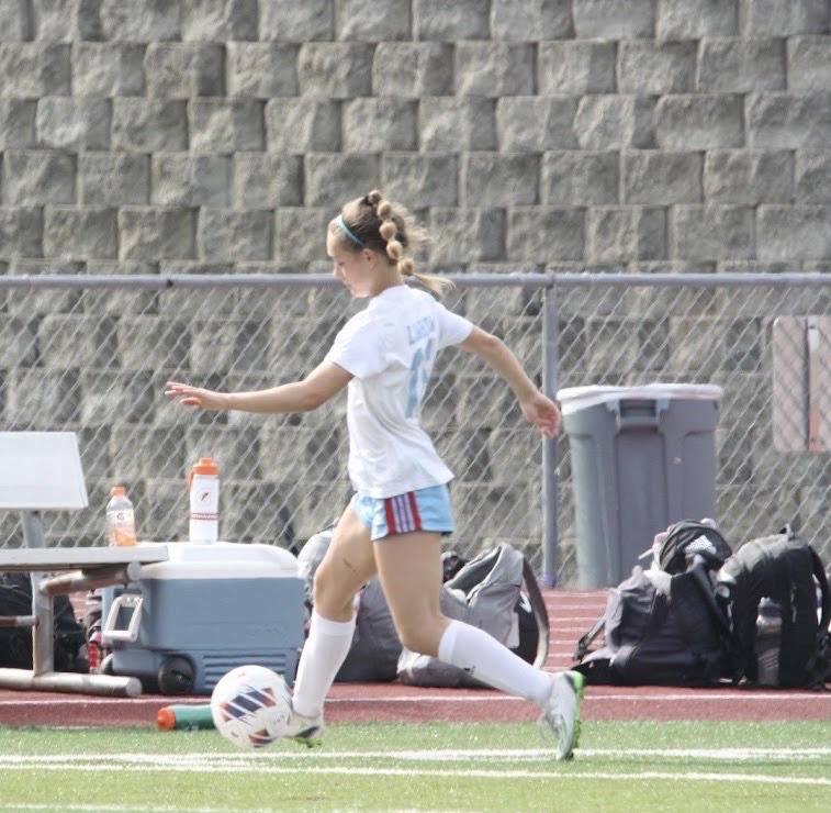Dribbling the ball, junior Maggie Leahy looks to find an open teammate. Leahy has been playing soccer her whole life and has been on varsity since she came to West in her freshman year. “Playing soccer has always been an outlet for me to have fun and be committed to something,” Leahy said.

