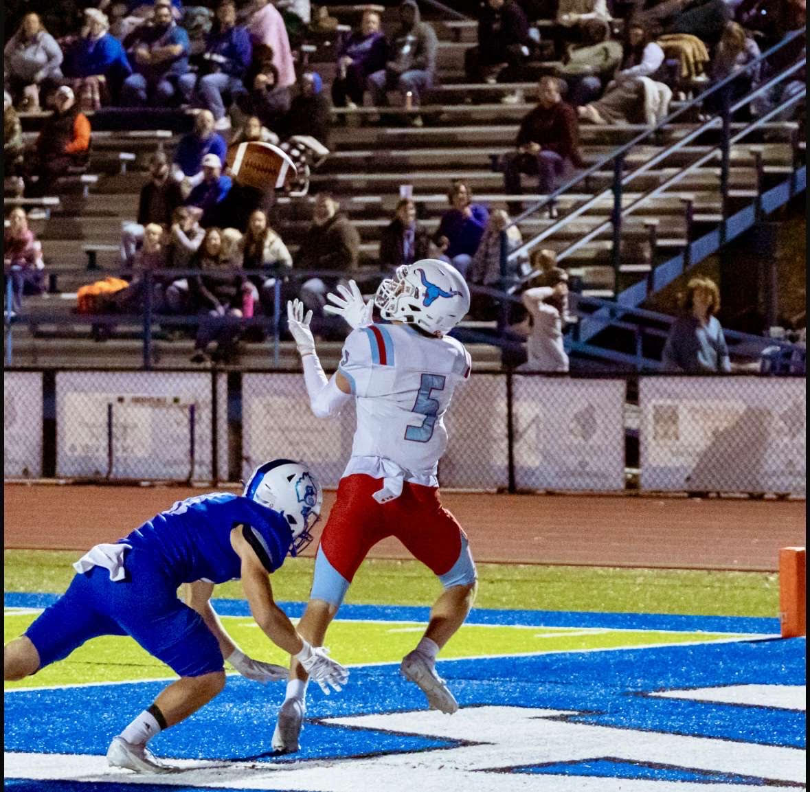 Junior Leyton Usry positions his arms to catch a touchdown as a defender falls below him. Usry is the starting wide receiver for the football team. “My favorite part about football is the adrenaline rush after catching a touchdown,” Usry said.
