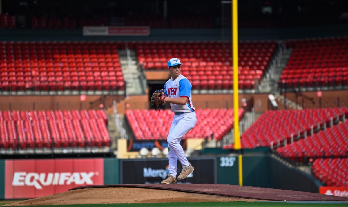 Pitching the ball on Apr. 14, senior Henry Wild and his team play against Belleville East. Wild was named scholar athlete of the year by St. Louis Post-Dispatch after maintaining a high cumulative GPA and staying involved with athletics for all of high school. “It’s an amazing honor. I feel very blessed to have the opportunity to represent my school [and] what [it] stands for,” Wild said.  