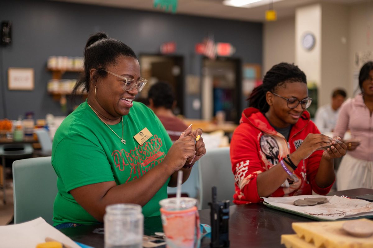 Hands kneading clay, junior principal Nancy Smith crafted a heart-shaped trinket dish while following instructions from sophomore Jania Farrow. Ceramics “Teach a Teacher Day” took place Aug. 29, allowing students to bring in a faculty member and guide them through the class. “I did [Teach a Teacher Day] last year with some students, and it was fun participating with the kids. [Jania] was so helpful and patient in teaching me. It made me see another side of a student who is very talented in her craft, and for her to show me how [to create ceramics] was awesome,” Smith said. 
