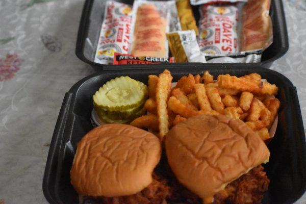 Pictured is the “Dave’s #2: 2 sliders w/ Fries”, overflowing with sauces and spice. 
